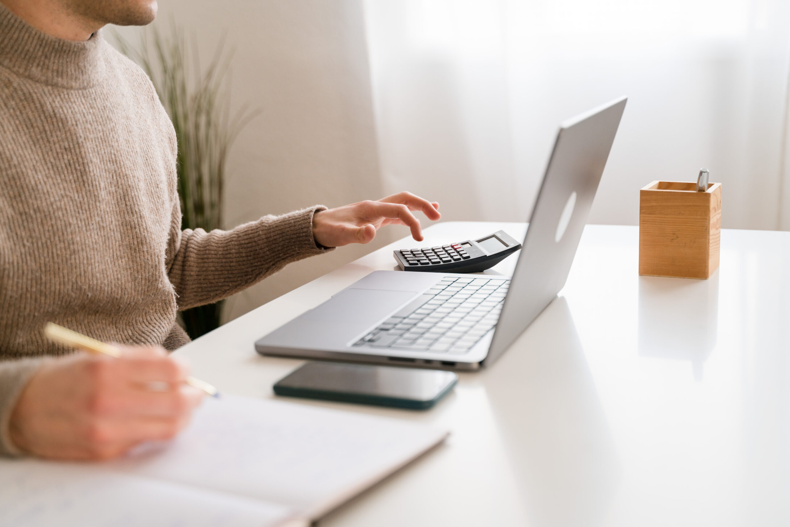 Crop man working on laptop